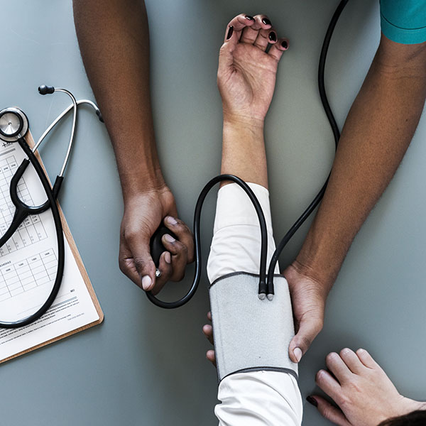 Nurse measuring patient blood pressure